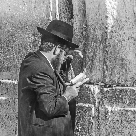 JERUSALEM - JAN 1,1994: Orthodox jewish man prays at the Western Wall in Jerusalem, Israel. Israel's annexation of East Jerusalem in 1967, including the Old City, was never internationally recognized.のeditorial素材