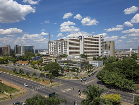 BRASILIA, BRAZIL - OCT 26, 2013: view to modern buildings with street crossing in Brasilia, Brazil. Brasilia was inaugurated in 1960 and the architect was Oscar Niemeyer.のeditorial素材