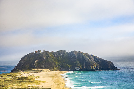 coast at Point Sur Light Station in fog with oceanの写真素材