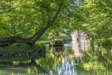 COLMAR, FRANCE - JUNE 23, 2018:  people enjoy a boat trip on a green canal in Colmar. The main canal is about 10 km long.のeditorial素材