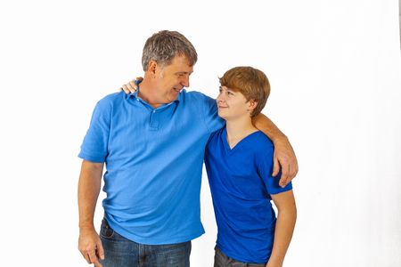 happy father hugging his sun in blue shirtの写真素材