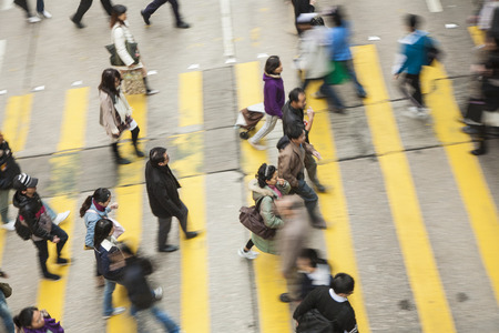 HONG KONG, CHINA - JAN 7, 2010: aerial view of people crossing a street at a pedestrian crossing.