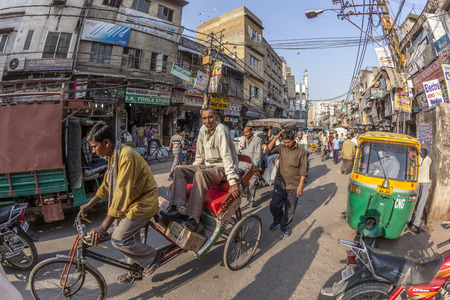NEW DELHI, INDIA - NOV 17, 2011: man carries  cargo and people with his rickshaw  in old Delhi, Chawri Bazaar.のeditorial素材