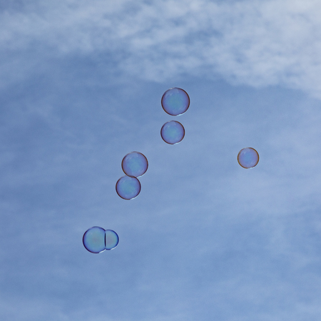 soapbubbles flying in the blue sky
