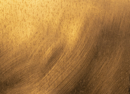 reflection of sun in metal gives a golden valuable looking bright backgroundの写真素材