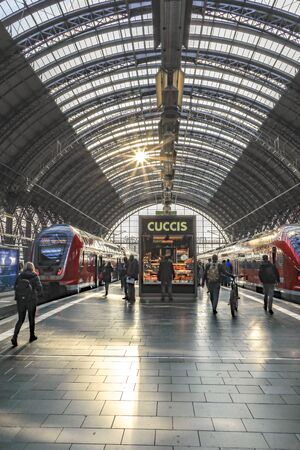 Frankfurt, Germany - FEB 28, 2019:  Passengers are waiting on a platform inside the Frsankfurt train station for their train.のeditorial素材