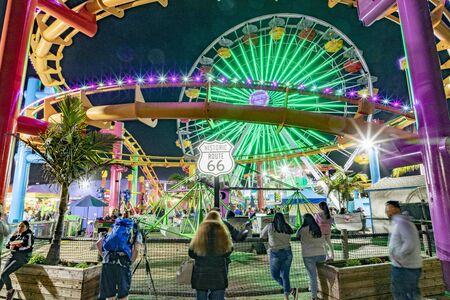 SANTA MONICA, USA - MAR 16, 2019: people enjoy the ocean park at Santa Monica pier by night.  The site is an iconic 100-year-old landmark for California visitors.のeditorial素材