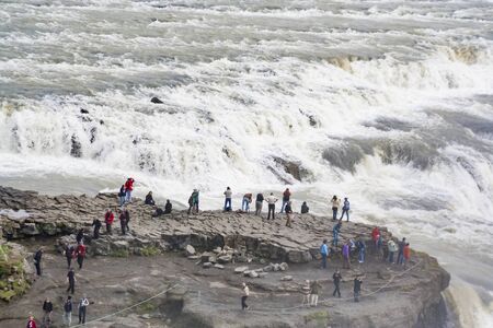 Reykholt, Iceland - JUNE 21, 2010: people watch the Hraunfossar waterfalls, located near Husafell and Reykholt in West Iceland.のeditorial素材