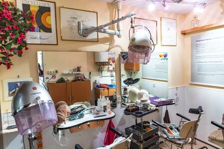 Anspach, Germany - July 2, 2019: old vintage chair and sink of a hair stylist in the architecture style of the 50th of last century in the Hessenpark, Neu Anspach.のeditorial素材
