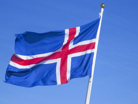 icelandic flag in wind under clear blue sky