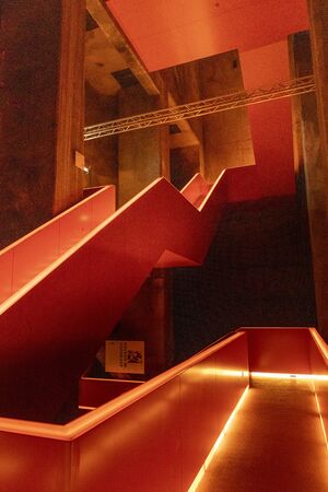 Essen, Germany - July 23, 2019:  Interior view of beautiful orange illuminated remarkable staircase is located at the entrance of Ruhr museum at Zeche Zollverein, Zollverein Coal Mine Industrial Complex.のeditorial素材
