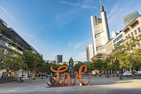 Frankfurt, Germany - July 23, 2019: view to skyline of Frankfurt with famous skyscraper built by the most important european banks and sculpture love of Mia Florentine.のeditorial素材