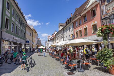 Fuessen, Germany - August 4, 2019: people enjoy visiting the central part of the historic town of Fuessen with the market place and enjoy a cafe.のeditorial素材