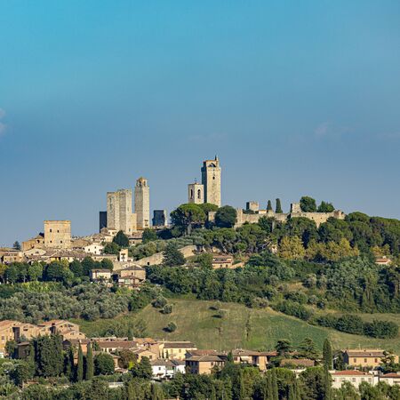 view to San Gimignano, old medieval typical Tuscan town with residential towers found therein in Italyの写真素材