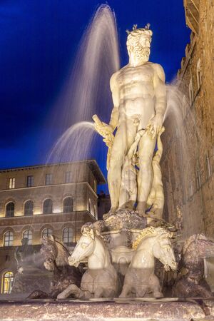 Italy, Florence, Neptune fountain in Signoria square (Piazza della Signoria) at nightの写真素材