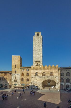 San Gimignano, Tuscany, Italy - August 9, 2019: Old medieval square and towers in typical Tuscan town. Town also called  Medieval Manhattan for residential towers found therein in italy.のeditorial素材