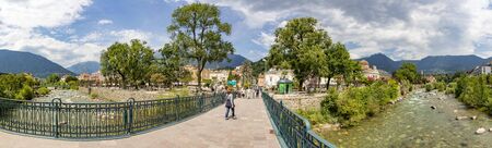 Meran, Italy - August 5, 2019: Bridge over the Passer river in the touristic city of Meran / Merano in Italy. Shot against a cloudy sky.のeditorial素材