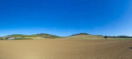 rural landscape with new plowed fields at the romantic street near Rothenburg ob der Tauber, Germanyの写真素材