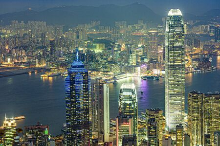 Hong Kong, Kowloon - January 8, 2010: Hong Kong view from Victoria Peak to the bay and the illuminated skyscraper  by night, Kowloon, Hongkong.のeditorial素材