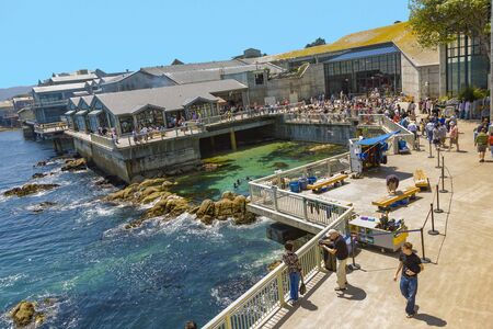 Monterey, USA - July 26, 2008: people enjoy the view to Monterrey aquarium and ocean at the sightseeing platform.のeditorial素材
