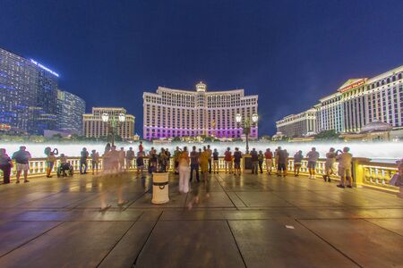 LAS VEGAS, USA - JUNE 15, 2012: people watch the Las Vegas Bellagio Hotel Casino, featured with its world famous fountain show, at night with fountains in Las Vegas, Nevada.のeditorial素材