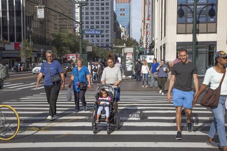 New York, USA - October 7, 2017: people crossing a street at seventh avenue at a pedestrian crossing inManhattan, New York, USA.のeditorial素材