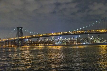 panoramic view to New York by night with Hudson river and bridgeの写真素材