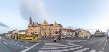 Pilsen, Czech Republic - December 31, 2019: people wait for the streetcar in the evening with panorama of Plzen, Czech Republic.のeditorial素材