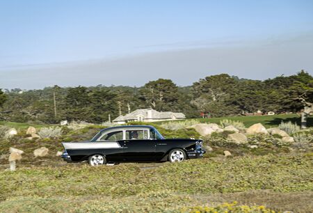 Carmel, USA - July 26, 2008: a classic car cruises along the 17 Mile drive near carmel at a classic car rally.のeditorial素材