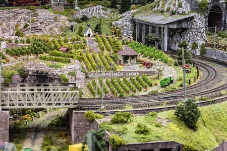 Frankfurt, Germany - January 27, 2020: detail of model railway with landscape, villages and operating train.のeditorial素材
