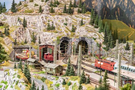 Frankfurt, Germany - January 27, 2020: detail of model railway with landscape, villages and operating train.のeditorial素材