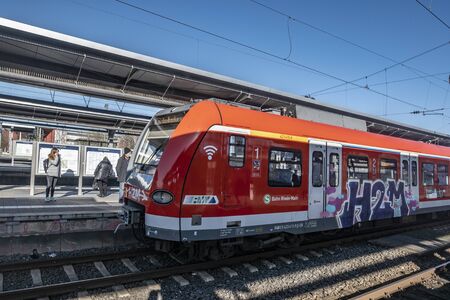 Frankfurt, Germany - February 5, 2020: people wait at the train station Frankfurt-Hoechst for the...