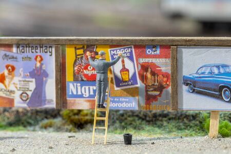Frankfurt, Germany - February 19, 2020: plastic man prepares advertising at a hoarding.のeditorial素材