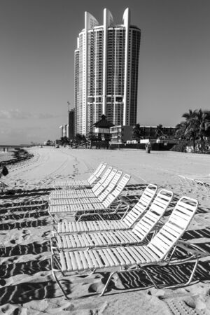 many lounges and umbrellas on beach, sunny dayの写真素材