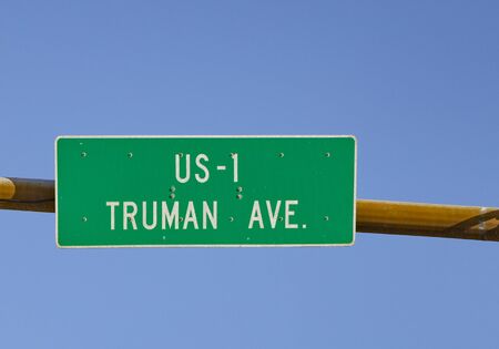 signage US Highway No 1 called Truman Ave starting in Key West with traffic lights under blue skyの写真素材
