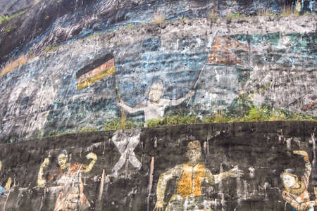 scenic prayer rock in the Himalaya in Nepal showing a nepali and german flag in the hand of a nepali man as symbol of friendshipのeditorial素材