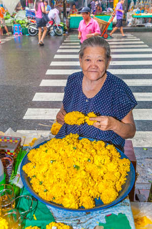 Bangkok, Thailand - May 12, 2009: unidentified woman sells flowers at the flower market Pak Klong Thalat early morning in Bangkok.のeditorial素材