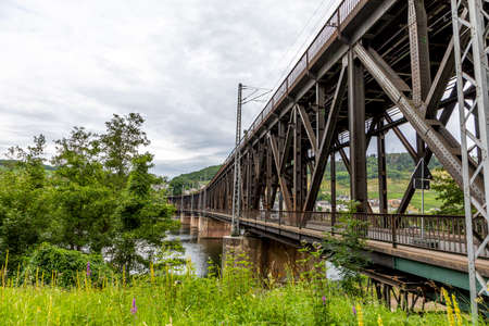 old iron bridge spans river Moselle, bridge is called Canon bridge and serves sicne the 17th century for trains and cars, Zellのeditorial素材