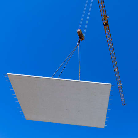 waterproof cocrete wall on a hook of a crane at the construction site in Germanyの写真素材