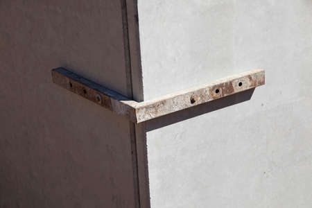 detail of iron angle to keep prefabricated concrete walls in position before stabilized with liquid...