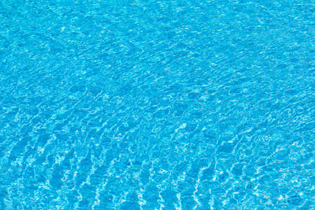 harmonic background of reflecting water in a pool with blue tiles