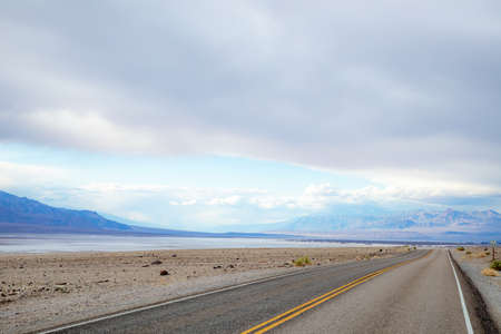 traveling in the death valley desert on empty roadの写真素材