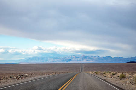 traveling in the death valley desert on empty road