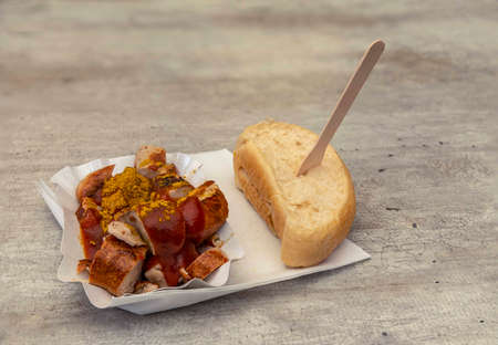 curry sausage with curry powder and ketchup and roll