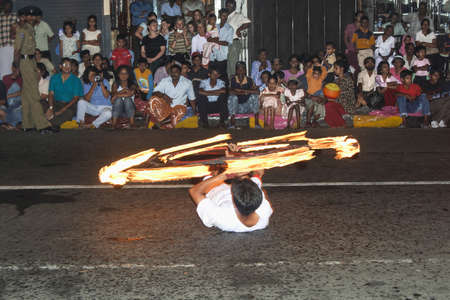 Kandy, Sri Lanka - August 12, 2005: fire dancer performs torch moving at the festival Pera Hera to celebrate the tooth of Buddha in Kandy, Sri Lanka.のeditorial素材
