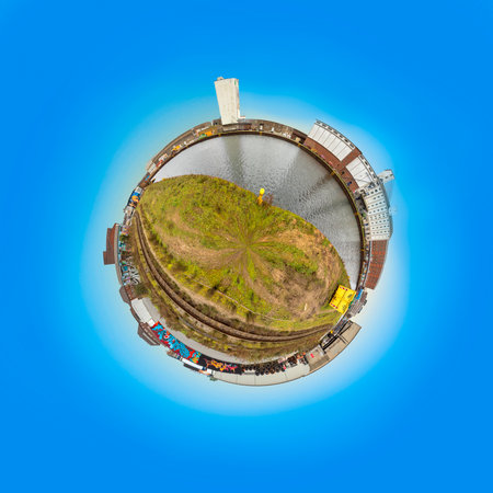 Dortmund, Germany - December 26, 2020: old harbor in Dortmund as tiny planet with old dock buildings and rotten painted walls.のeditorial素材