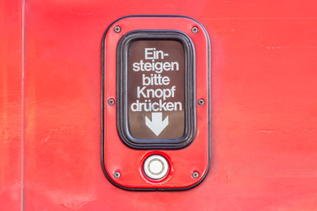 Vienna, Austria - April 28, 2015: sign for entrance please press button (German: Get in please press button) at a streetcar in Vienna, Austria.のeditorial素材