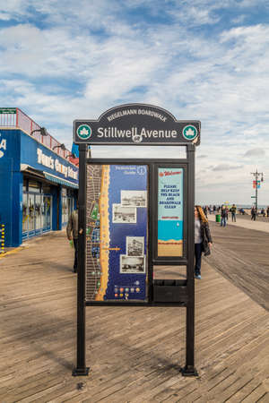 Coney Island, USA - October 25, 2015: signage at famous stillwell avenue, also the so called Riegelmann Boardwalk at the beach of Coney Island.のeditorial素材
