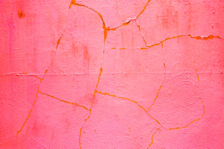 old cracked orange plaster wall in detailの写真素材