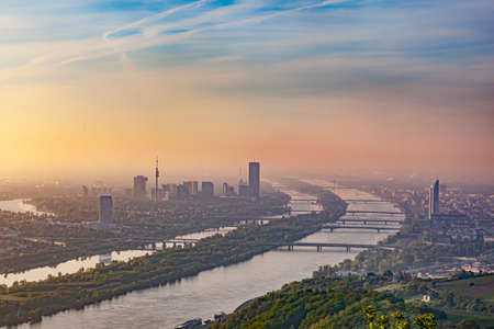 scenic view to Vienna and river Danube in dawn with forest in foregroundの写真素材